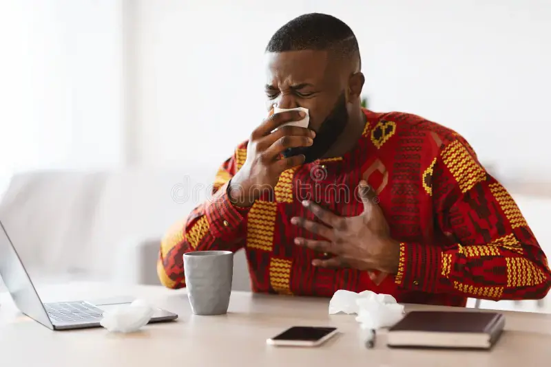 seasonal-flu-ill-african-man-tribal-clothes-feeling-unwell-workplace-seasonal-flu-portraif-ill-afric.webp
